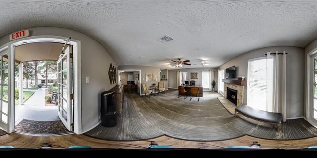 Entrance and leasing office with fireplace and seating area.