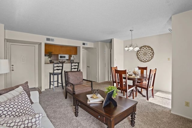 Living room and dining area with kitchen view.