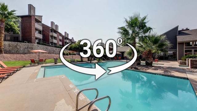 360 virtual tour of the apartment complex swimming pool with lounge chairs and umbrellas.