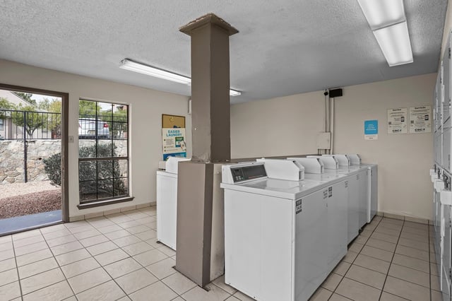 Mailroom with multiple banks of gray mailboxes