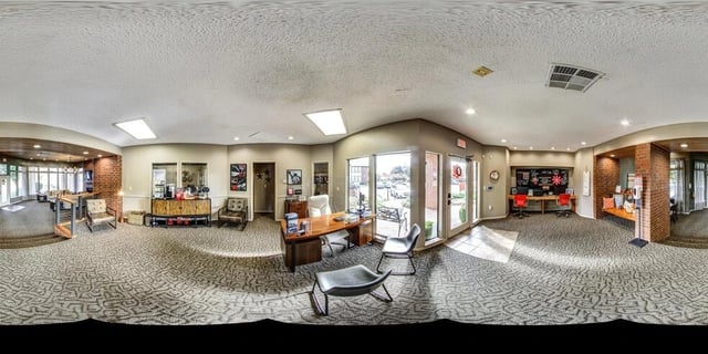 Reception area with desks, seating, and coffee station.