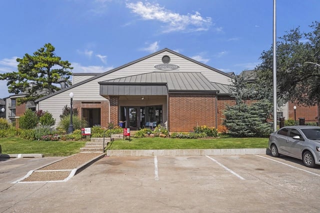 Exterior of the leasing center with parking lot in foreground.