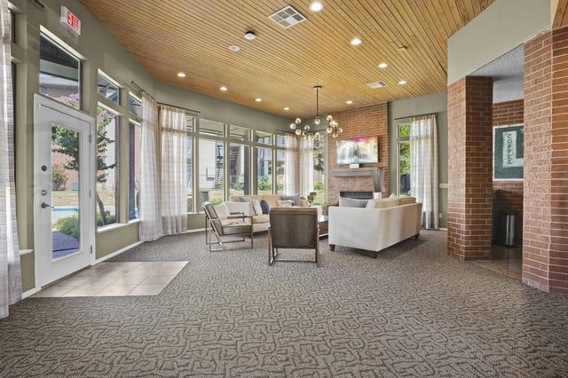 Lobby with seating area, fireplace, and TV.