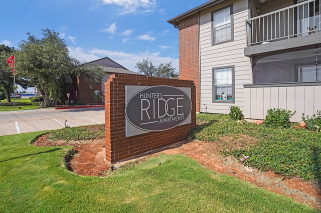 Hunter's Ridge Apartments monument sign with brick base.
