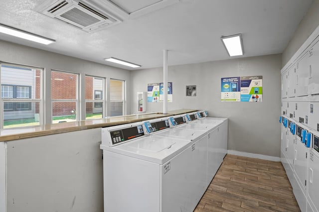 Laundry room with multiple washers and dryers.