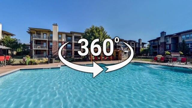 360-degree view of a swimming pool and apartment buildings.