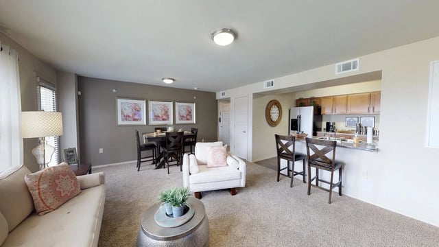 Living room, dining area, and kitchen in an apartment