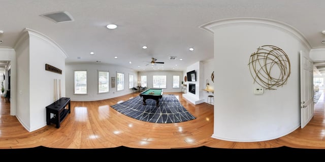 Community room with a pool table, fireplace, and seating.