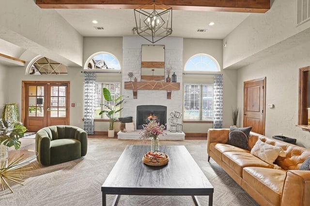 Community lounge area with a fireplace and comfortable seating.