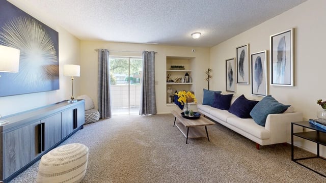 Living room with a sofa, coffee table, and large wall art.