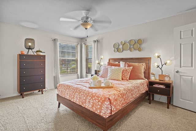 Bedroom with a king-size bed, dresser, and nightstand.
