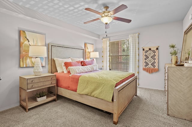 Bedroom with a queen-size bed, nightstand, dresser, and window.