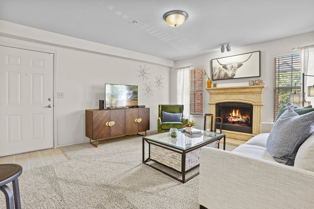 Cozy living room with a fireplace, TV, and comfortable seating.