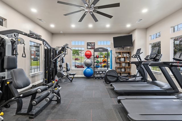 Fitness center with treadmills, elliptical, and weight machines.