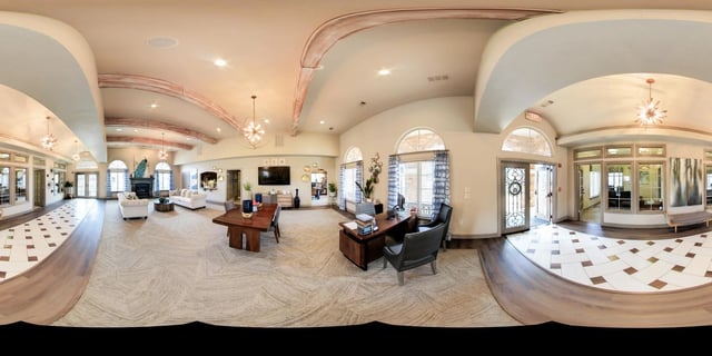 Spacious leasing office with a fireplace, seating areas, and a reception desk.