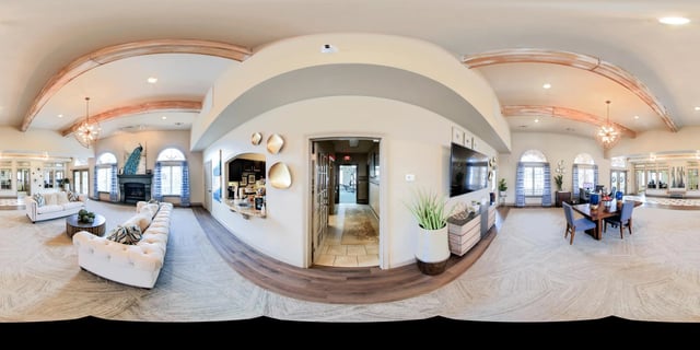 Spacious community lounge with seating areas, fireplace, and a bar.