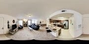 360 virtual tour of a living room and kitchen with fireplace and island.