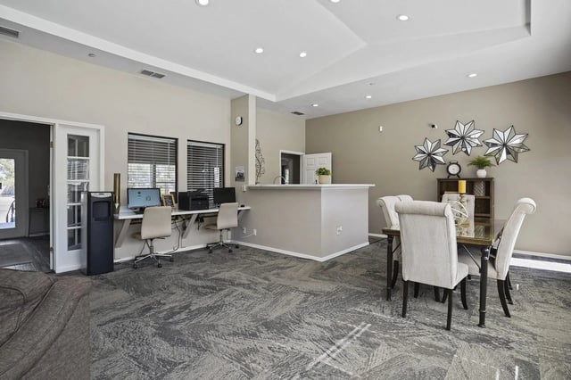 Business center with computers, printers, and a water cooler.