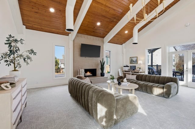 Stylish clubhouse living area with vaulted wood ceilings, fireplace, and comfortable seating.