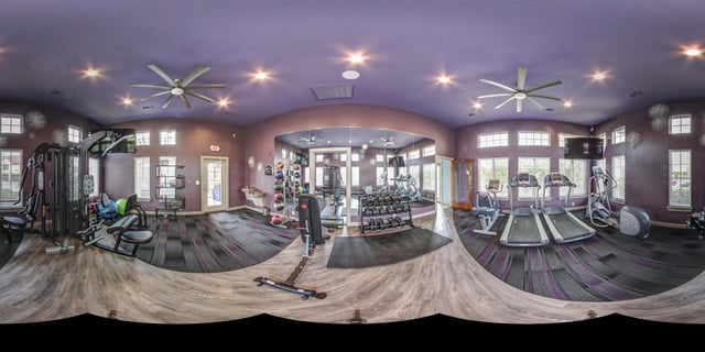 Fitness center with treadmills, elliptical, weight machines, and free weights.