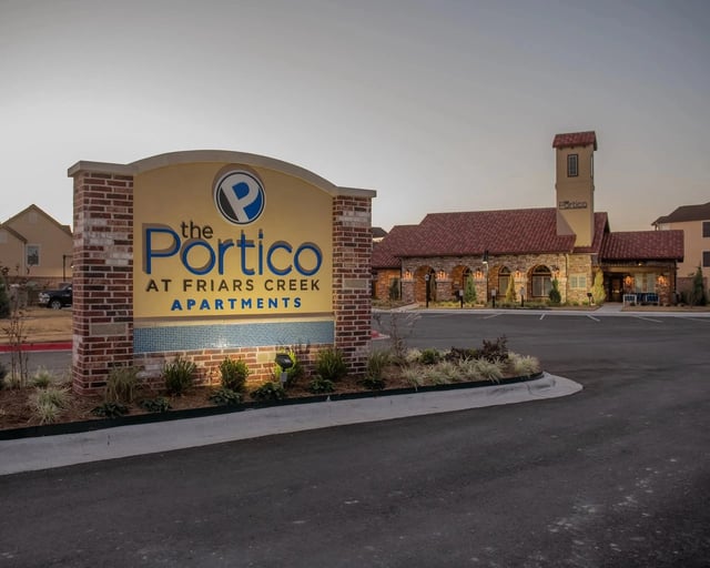 The Portico at Friars Creek Apartments monument sign and building exterior.