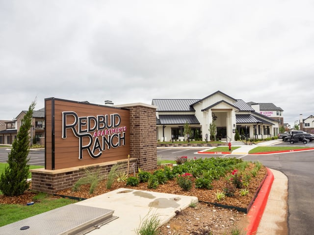Exterior view of Redbud Ranch Apartments sign and front entrance.