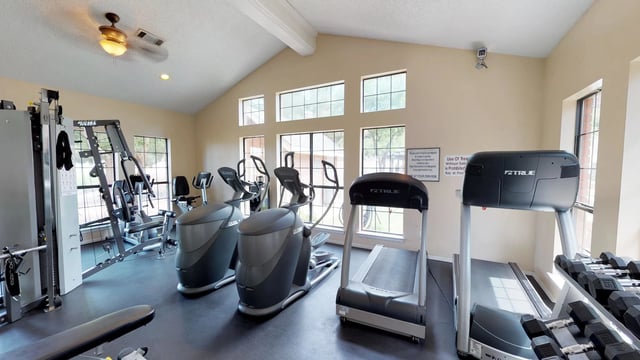 Kitchen with white appliances, wood cabinets, and dual sink.