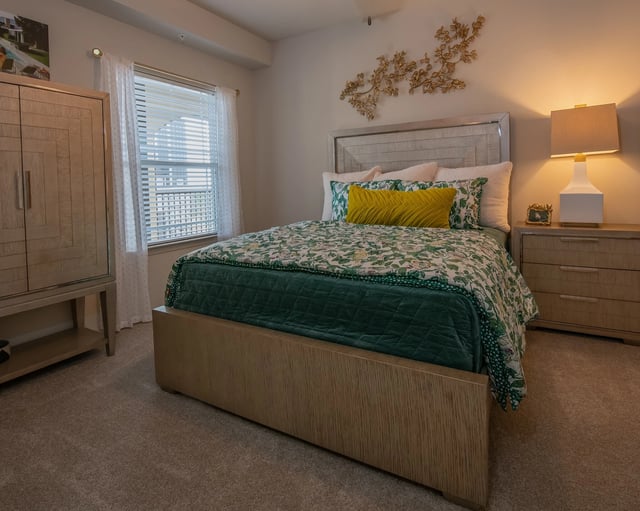 Bedroom with a queen-size bed, nightstand, and wardrobe.