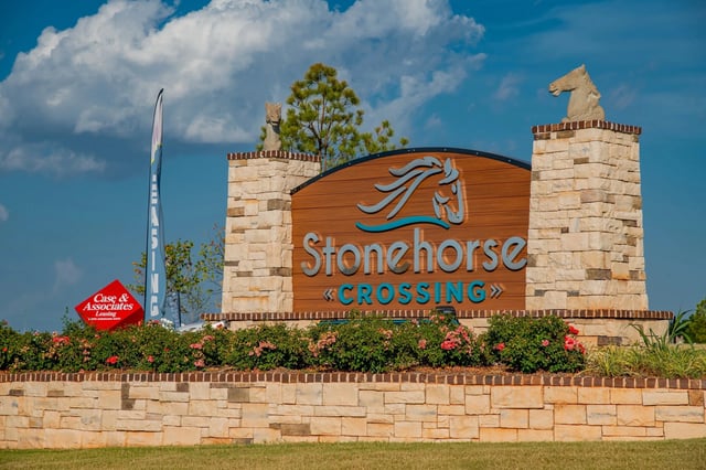 Stonehorse Crossing entrance sign with stone pillars and landscaping.