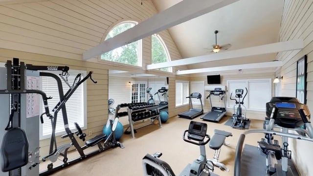 Fully equipped fitness center with cardio machines and free weights.