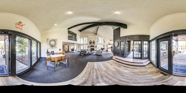 Spacious and elegant leasing office with a reception desk and a large seating area.