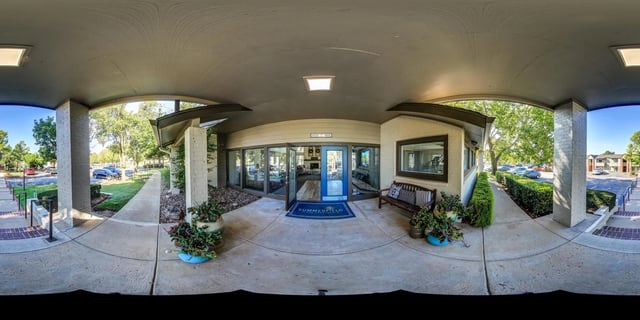 Entrance to Summerfield apartment complex with blue doors and a welcome mat.