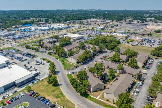 Aerial view of a large apartment community with multiple buildings and parking lots.