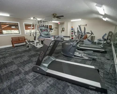 Fitness center with treadmills, ellipticals, and weight machines.