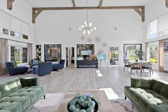 Modern community lounge area with green seating and large windows