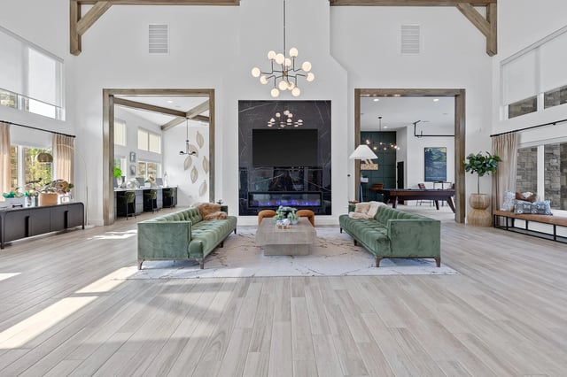 Spacious lounge area with green sofas and modern decor