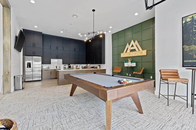 A billiards table and stylish seating area in the community lounge.