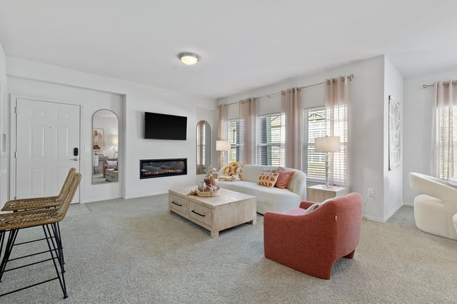 Living room with a fireplace, television, sofa, and coffee table.