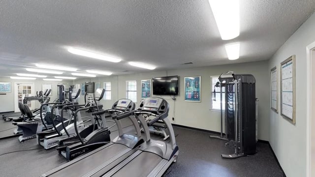 Fitness center with treadmills, stair climbers, and weight machines.