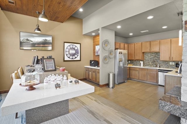 Community kitchen area with coffee station and seating.
