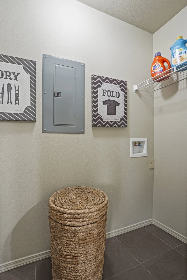 A laundry room with a dryer and a fold sign.