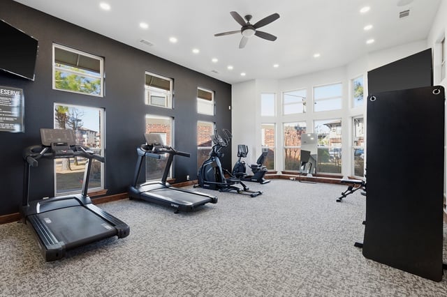 Gym with treadmills, elliptical, and recumbent bike.