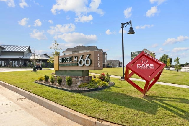 Ridge at 66 Apartment Homes monument sign and red cube sculpture.
