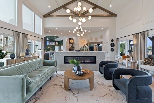 Stylish lounge area with a fireplace, comfortable seating, and modern lighting.