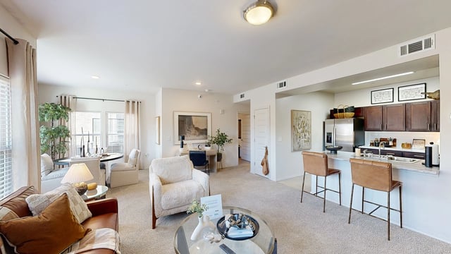 Spacious living room and kitchen area in an apartment.