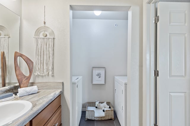A bathroom with a white door and a white towel on a basket.