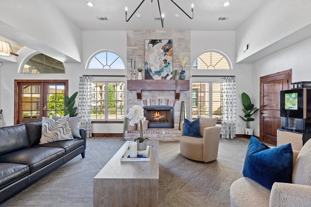 A modern living room with a fireplace and a large painting on the wall.