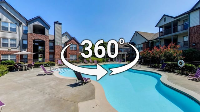 360-degree view of an outdoor swimming pool with lounge chairs and surrounding apartment buildings.
