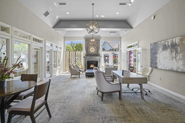 Bright lobby lounge with a fireplace, contemporary seating, and large windows.