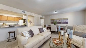 Living room and dining area with open kitchen view.
